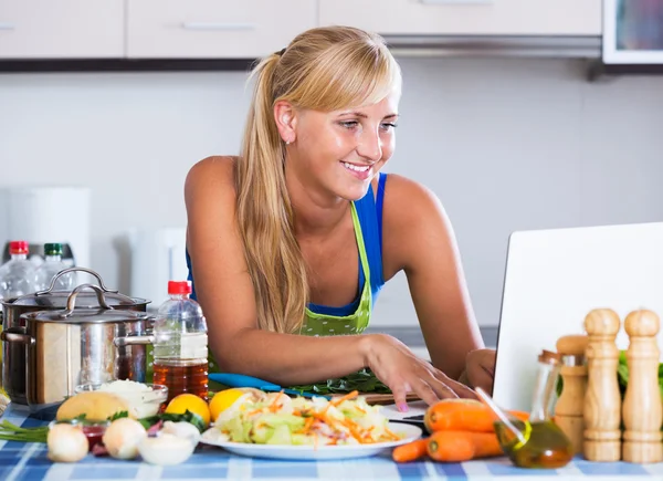 Blonde girl searching new recipe — Stock Photo, Image