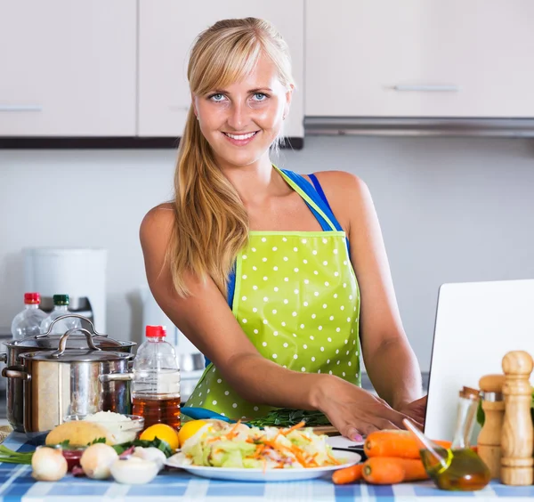 Blonde girl searching new recipe — Stock Photo, Image