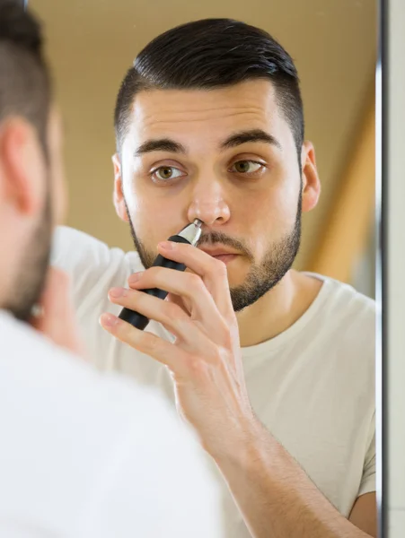 Guy remove hair from his nose — Stock Photo, Image