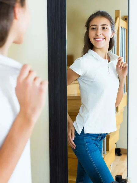 Young girl trying on a t-shirt — Stock Photo, Image