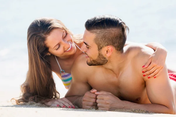 Pareja feliz disfrutando en la playa de arena —  Fotos de Stock