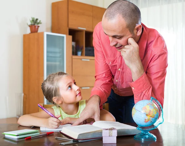 Man and little girl with books indoor — Stock Photo, Image