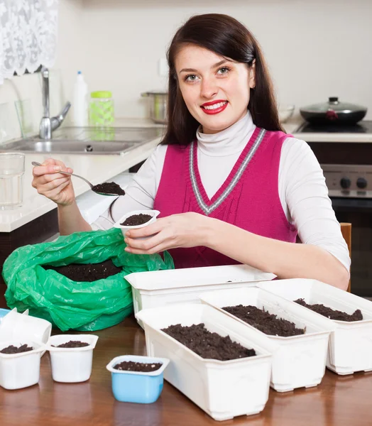 Woman making ground for sprouts — Stock Photo, Image