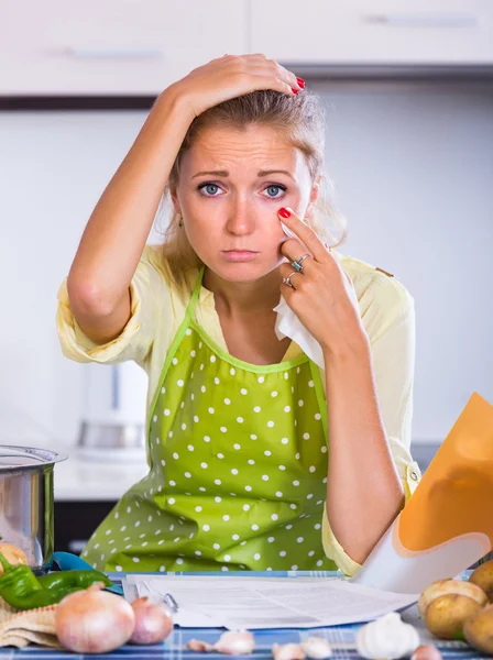 Sad girl with banking statement at home — Stock Photo, Image