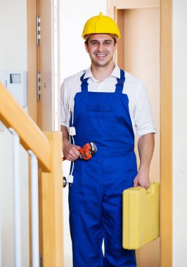 Happy handyman in uniform clipart