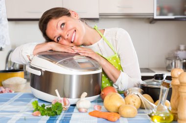 Housewife cooking with multicooker clipart