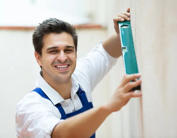 Specialist making wall plane — Stock Photo, Image
