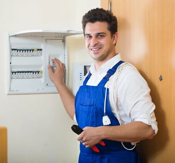 Handyman near electric meter — Stock Photo, Image