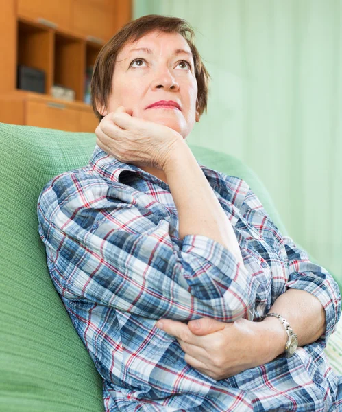 Stressed female pensioner on couch — Stock Photo, Image