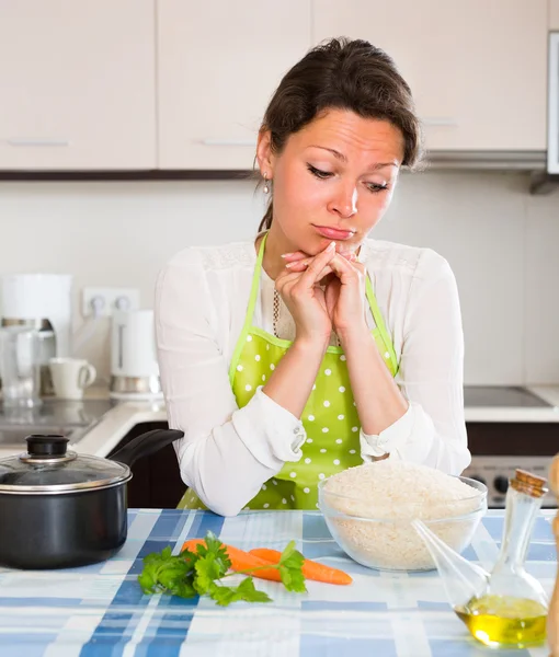 Triest huisvrouw eten koken — Stockfoto