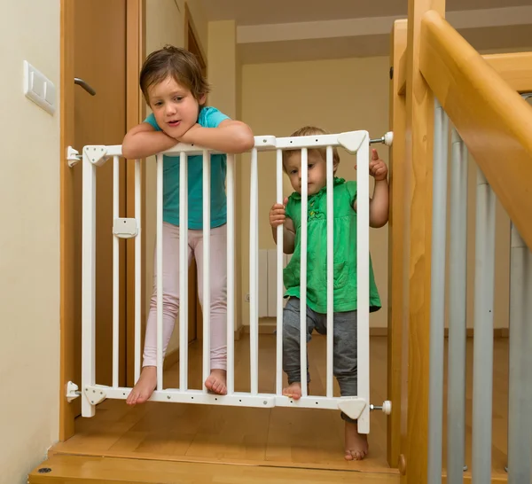 Little sisters near stair gate — Stock Photo, Image