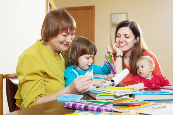 Happy family sketching on paper — Stock Photo, Image