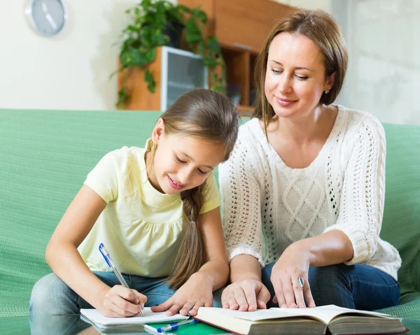 Mother with daughter doing homework Stock Picture