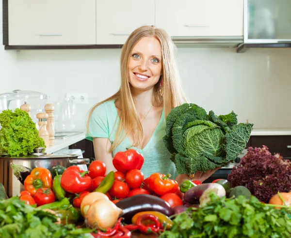 Woman with raw cabbage and other vegetables — Stock Photo, Image