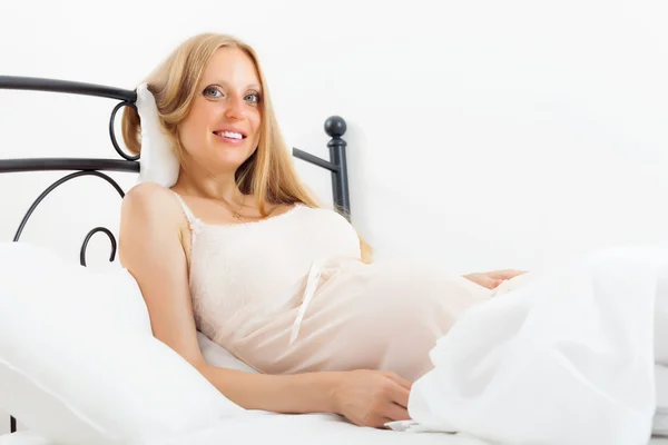 Cheerful pregnant woman in nightdress — Stock Photo, Image