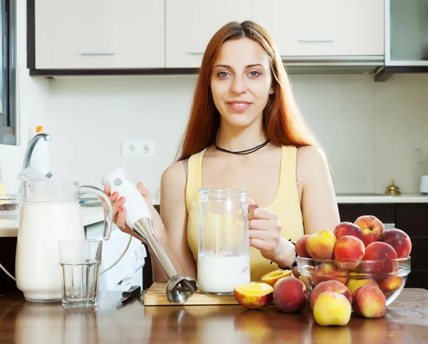 Chica positiva cocinando bebidas lácteos —  Fotos de Stock