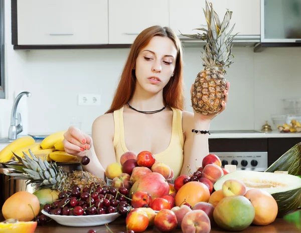 Woman with heap of fruits — Stock Photo, Image