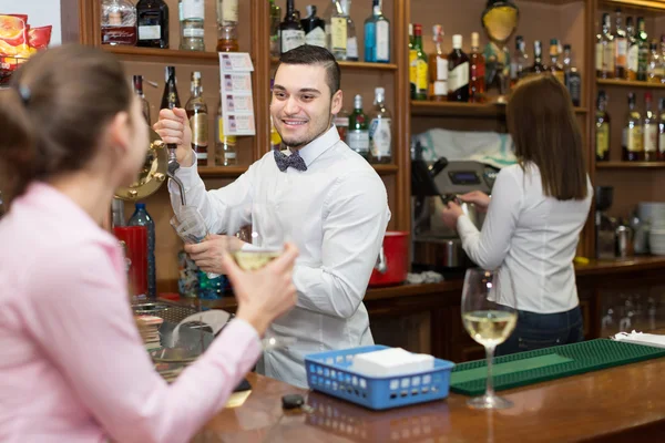 Girl flirting with barman at counter — Stock Photo, Image