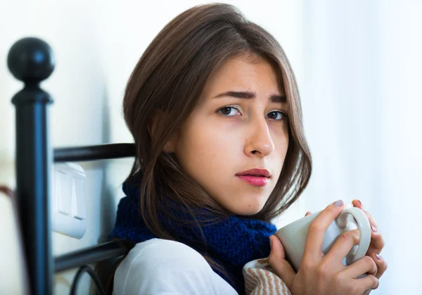 Sick teenage girl with tea and medication — Stock Photo, Image