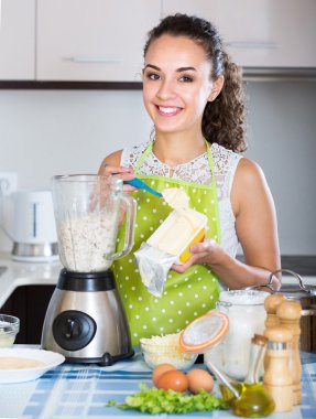Girl preparing pate with kitchen blender clipart