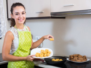  girl frying delicious crocchette  clipart