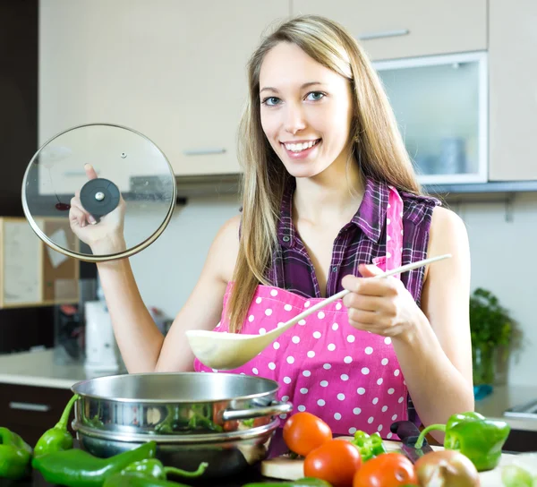 Kvinna matlagning soppa i köket — Stockfoto