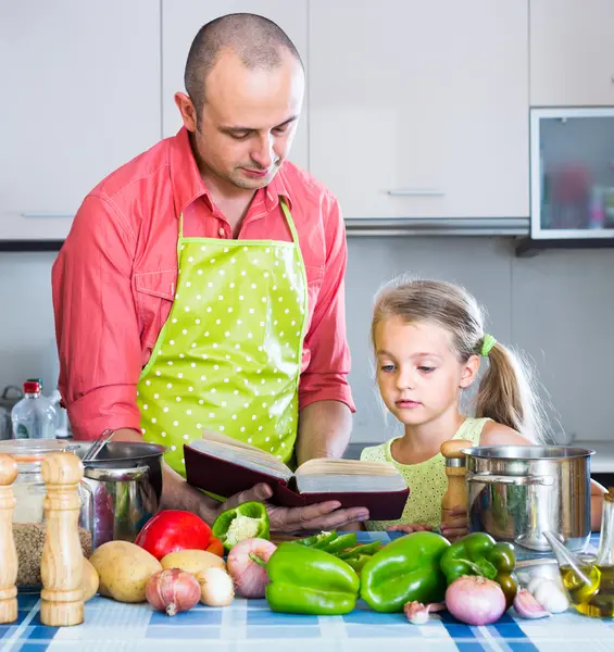 Girl helping father to prepare dinner — Stock Photo, Image