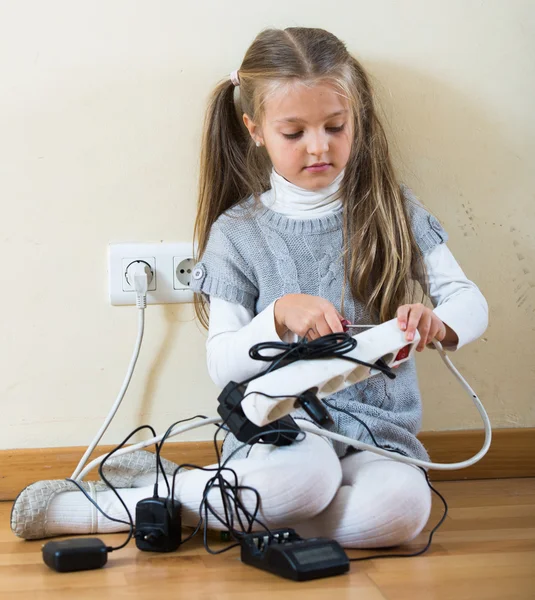 Girl wearing ponytails playing with electricity — Stock Photo, Image