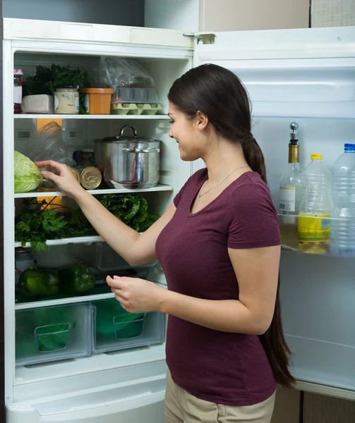 Girl near refrigerator at home — Stock Photo, Image