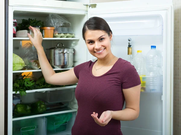 Girl near refrigerator at home — Stock Photo, Image