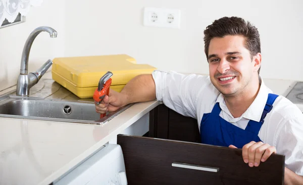 Professional plumber with tools near sink — Stock Photo, Image