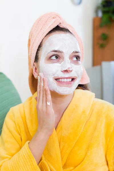 Girl applying cream on skin
