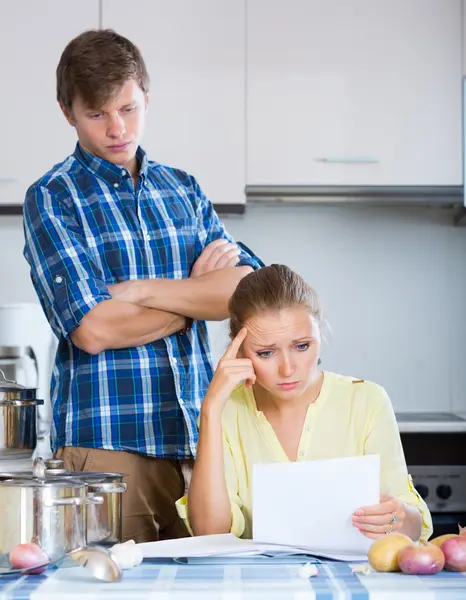 Couple with serious faces in kitchen — Stock Photo, Image