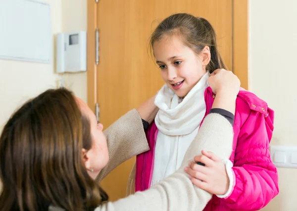 Caring mother dressing her daughter — Stock Photo, Image