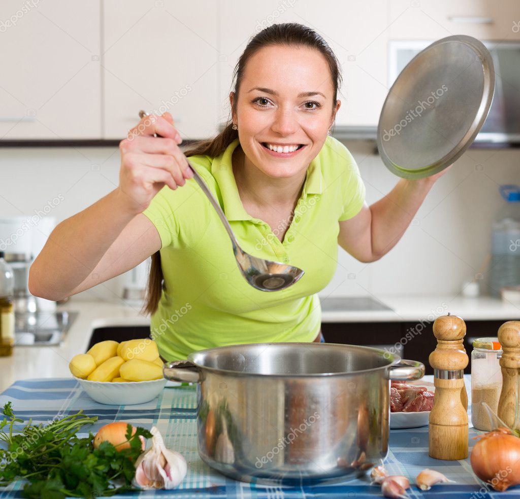 Housewife cooking soup at kitchen Stock Photo by ©Jim_Filim 94875452