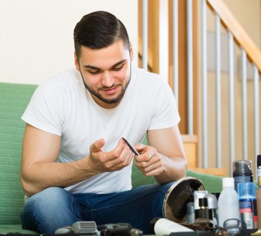 Man doing manicure at home clipart
