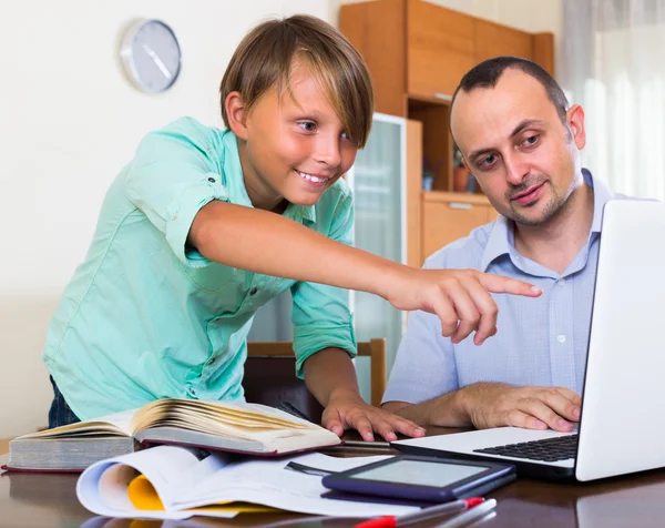 Adult man and boy with laptop indoor — Stock Photo, Image