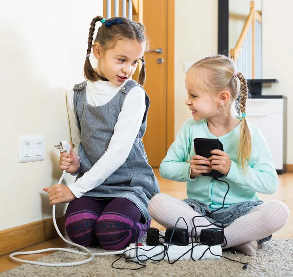 Children playing with sockets indoors — Stock Photo, Image