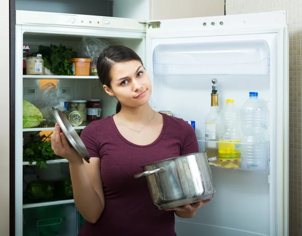 Woman sniffing at foul food — Stock Photo, Image