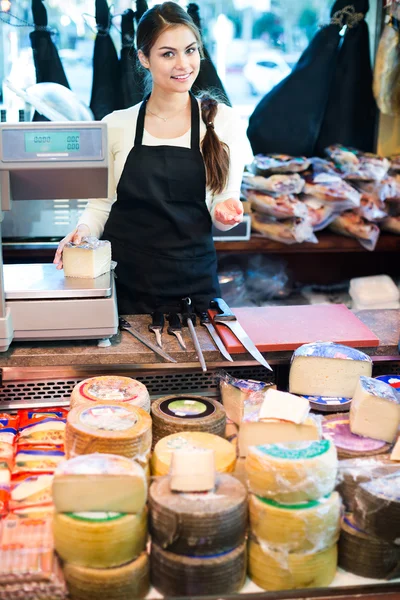 Veselá mladá prodavačka prodat sýr — Stock fotografie