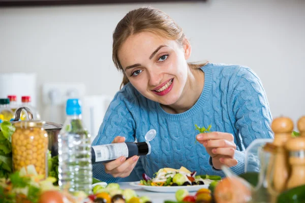 Sorridente ragazza decorazione insalata sul piatto — Foto Stock