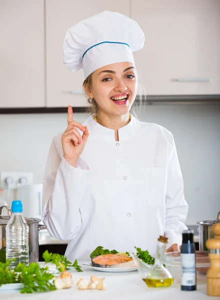 Cook with prepared trout in plate — Stock Photo, Image