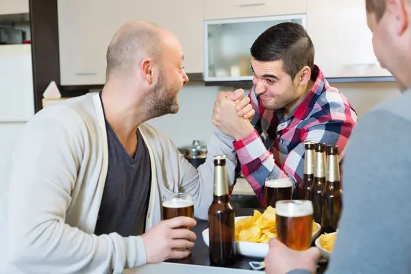 Smiling and drunk men armwrestling — Stock Photo, Image