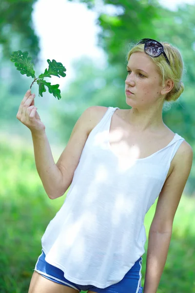 Girl with oak leaves in the hands — Stock Photo, Image