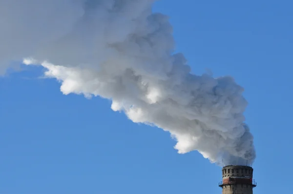 Fumée industrielle de cheminée sur ciel bleu — Photo