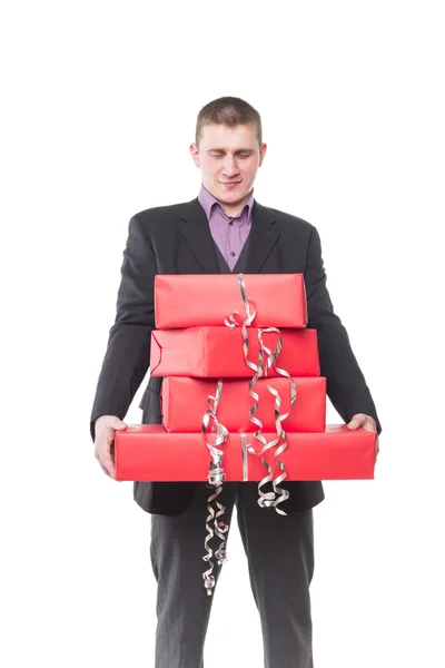 Man in a suit with gift boxes — Stock Photo, Image