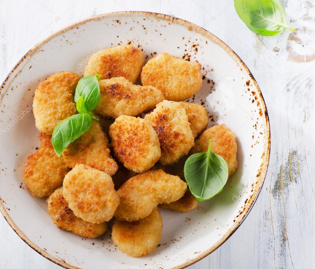 Crispy chicken nuggets on plate