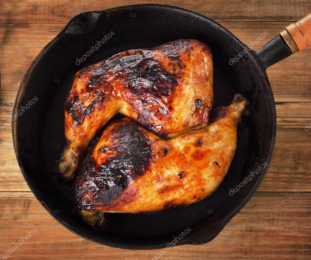 Roasted chicken legs on iron skillet — Stock Photo © bit245 101121474