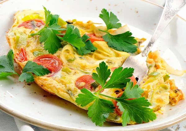 Omelet with vegetables in white plate. — Stock Photo, Image