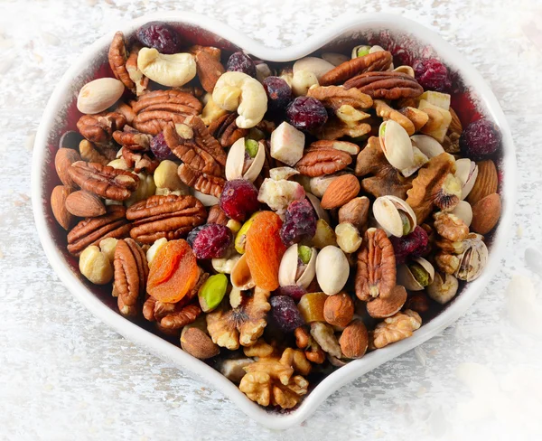 Nuts on heart plate — Stock Photo, Image